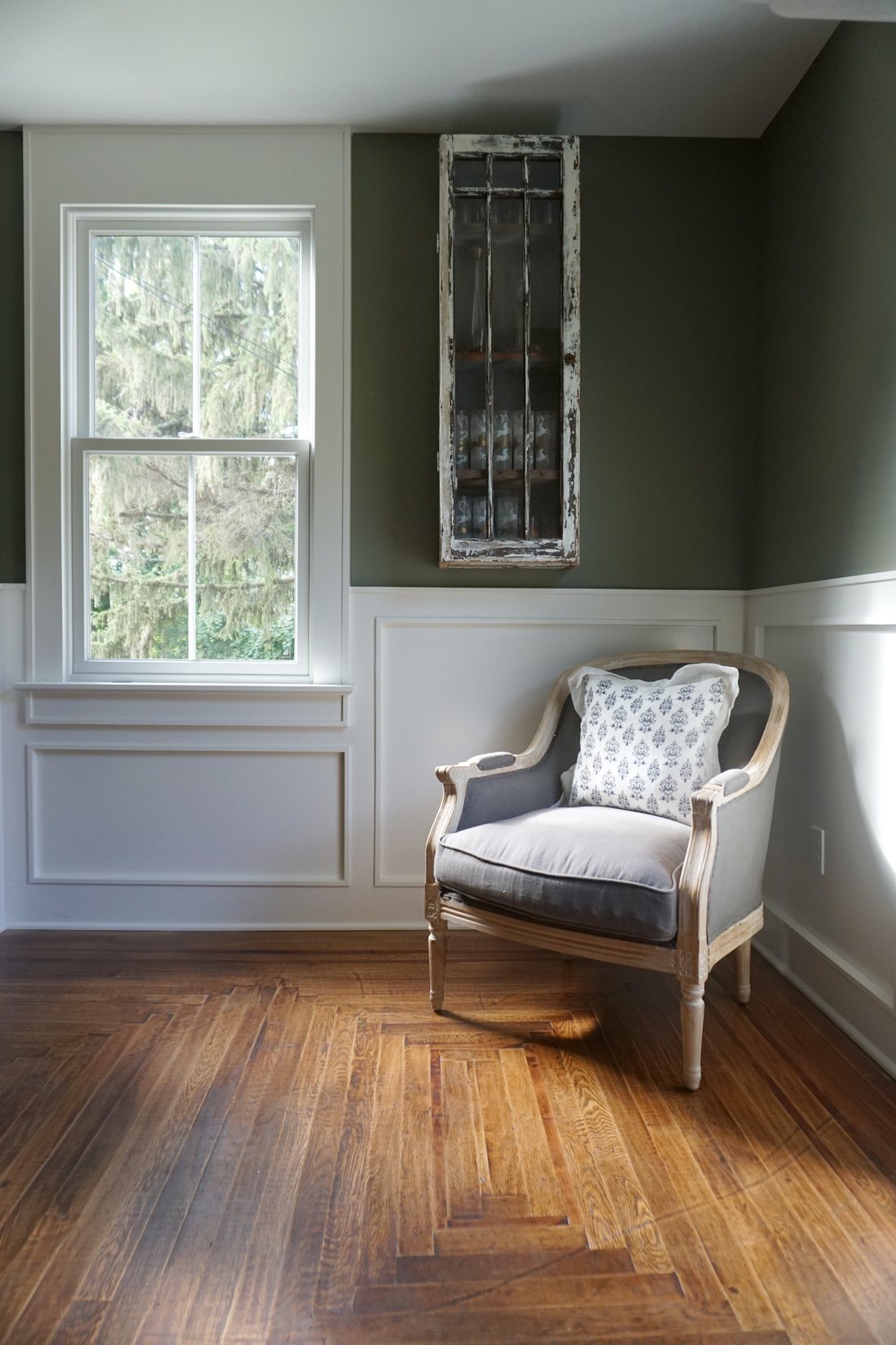 Olive-painted room with wainscoting, a side chair and original inlay wood floor: 1790 Farmhouse Renovation, Milton NY
