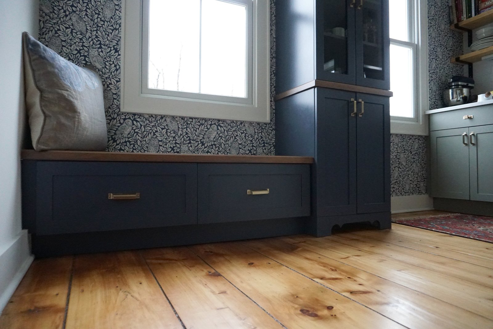 Navy built-in window bench and cabinet over wide pine floorboards: 1790 Farmhouse Renovation, Milton NY