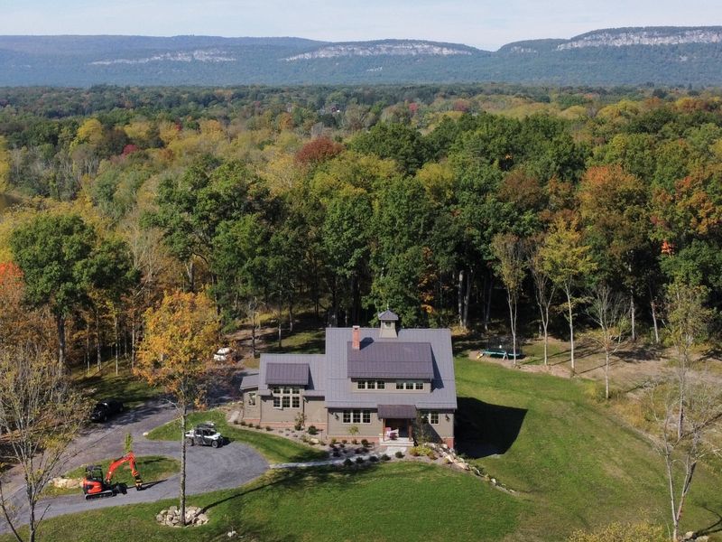Aerial view of a custom new construction home by Wiley Construction, with the Shawangunk Ridge behind